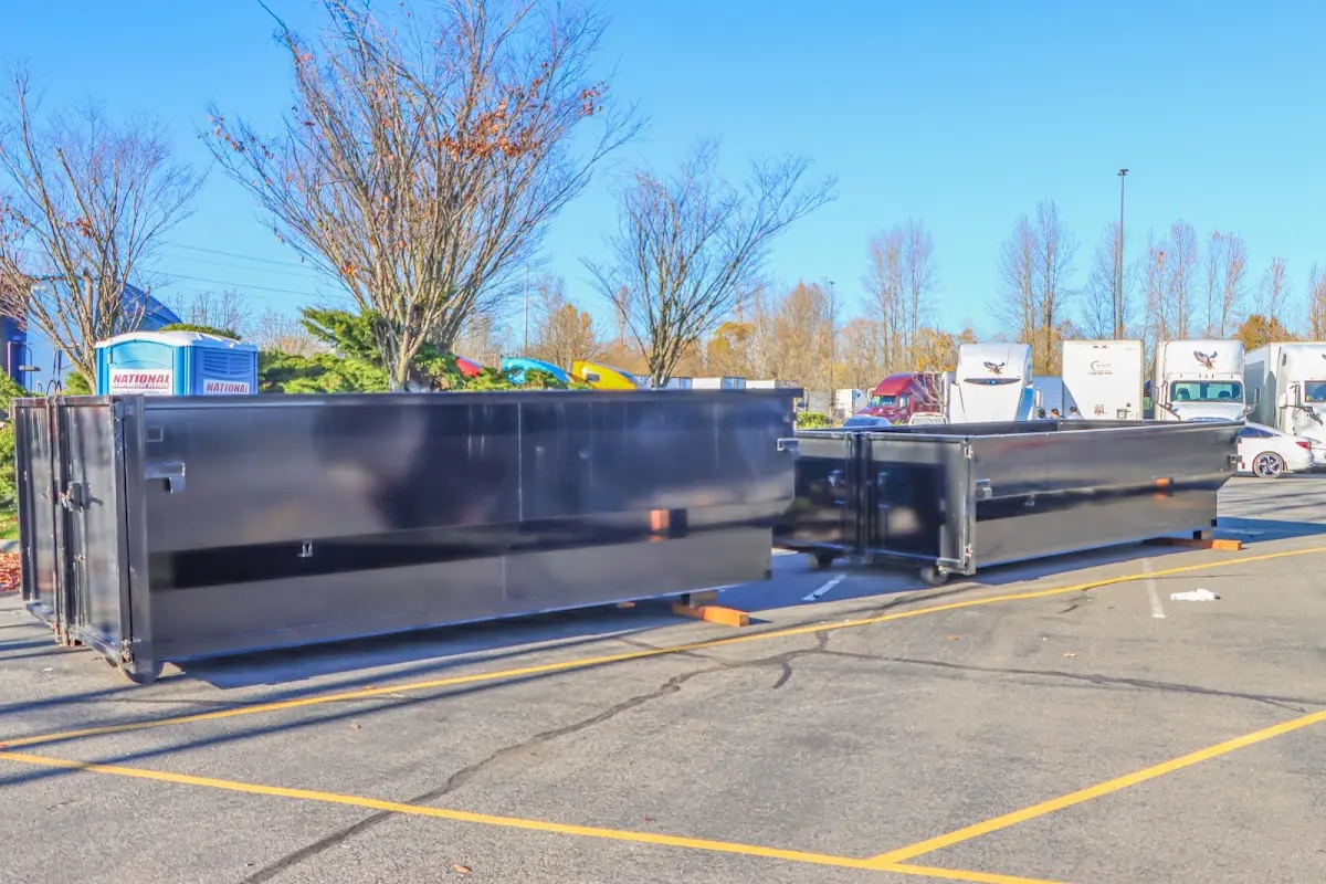 Professional dumpster rental service with roll-off container on residential driveway in River Falls